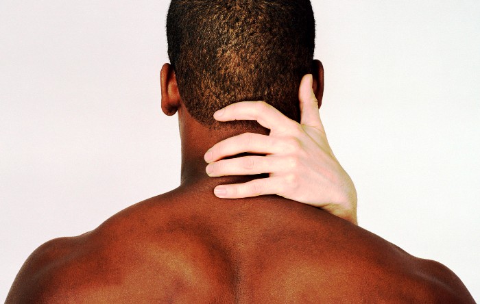 Woman's hand holding man's neck, rear view, close-up