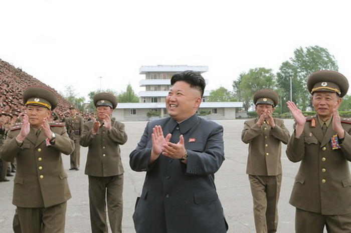 North Korean leader Kim Jong Un applauds during a photo session with soldier-builders who took part in building the workers' hostel of Kim Jong Suk Pyongyang Textile Mill