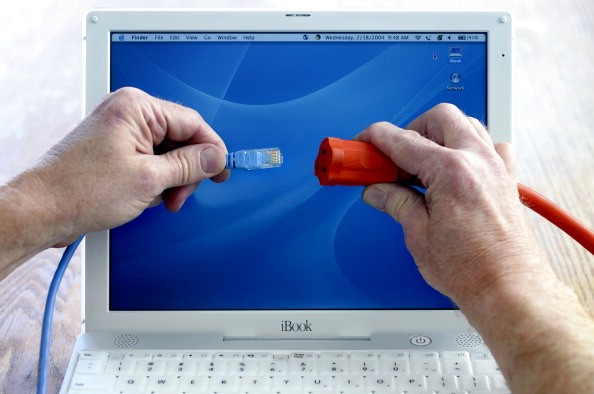 Photo illustration of laptop computer, ethernet cable and AC extension cord to symbolize Internet service over power lines to home and office. (The Denver Post / Jerry Cleveland)