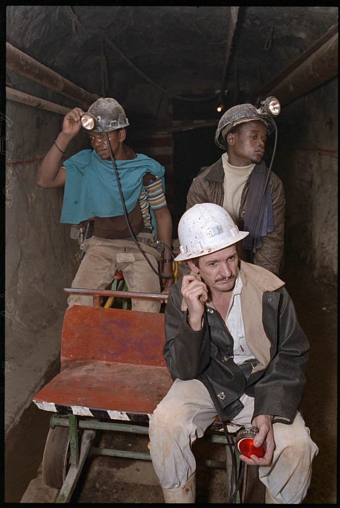  Miners Descending into Gold Mine 