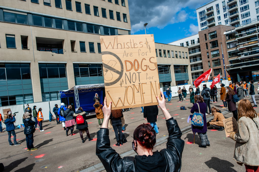  A protester holds a placard against sexual assault during 